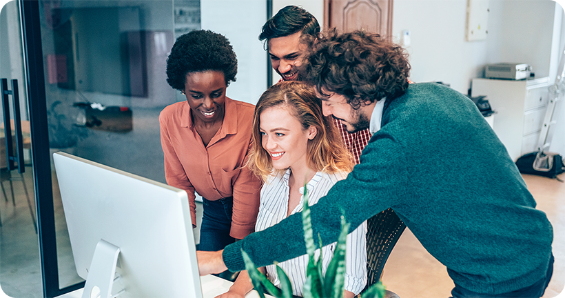 4 Personen schauen auf einen Computerbildschirm
